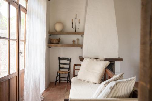 a living room with a couch and a chair at Finca Luca Oliva in Zahara de la Sierra
