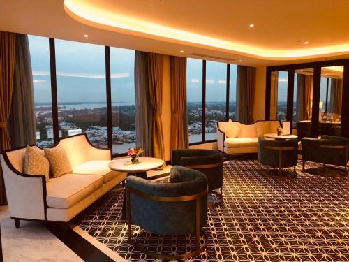 a hotel lobby with couches and chairs and windows at Charmant Suites a Boutique Hotel Can Tho in Can Tho