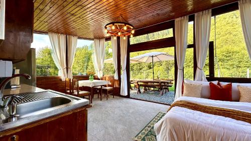 a kitchen with a bed and a sink in a room at The Heaven Sibiu in Sebeşu de Sus