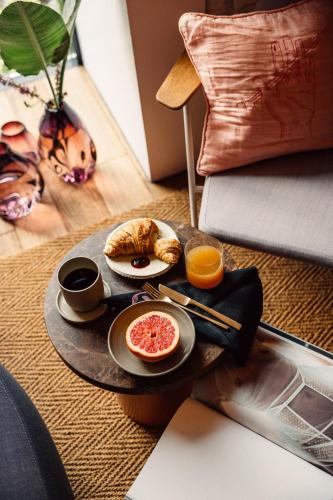 a tray with breakfast foods on a table at Libertine Lindenberg in Frankfurt/Main