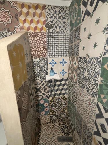 a bathroom with a shower with lots of tiles at Riad Sanwa in Marrakech
