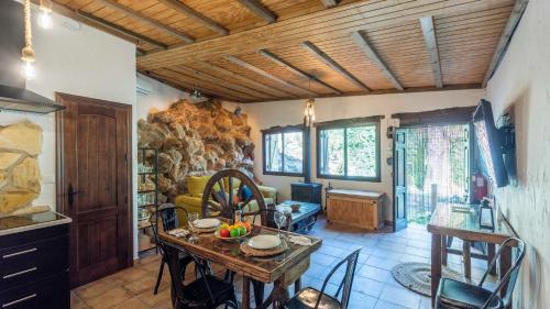 a kitchen and dining room with a table and chairs at Casa de La Cascada Iznájar by Ruralidays in Iznájar