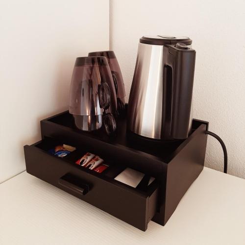 a black holder with a coffee pot on it at Corte Mantovani in Colà di Lazise