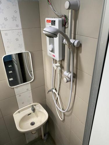 a bathroom with a toilet and a sink at Ayem Homestay UTHM in Parit Raja