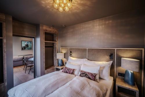 a bedroom with a large bed in a room at Henningsvær Bryggehotell - by Classic Norway Hotels in Henningsvær