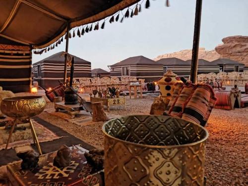 a desert with a group of chairs and a tent at WADI RUM STAR WARS CAMP in Wadi Rum