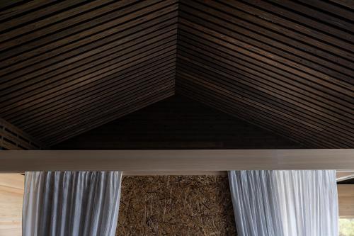 a wooden ceiling in a room with a window at シーサイド佐竹 in Kyotango