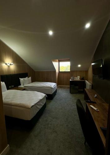 a hotel room with two beds and a window at WELLFORT HOTEL in Samarkand