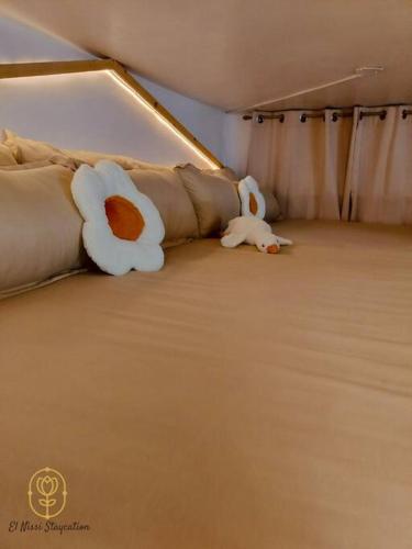 a stuffed animal is laying on a bed at El Nissi Staycation, The Play Cabin, Beside Enchanted Kingdom in Santa Rosa