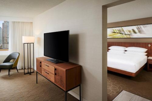 a bedroom with a bed and a flat screen tv at Delta Hotels by Marriott Toronto Mississauga in Mississauga