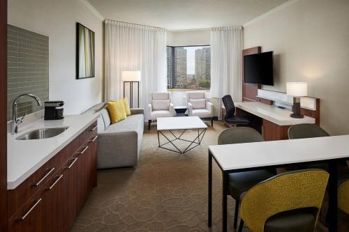 a hotel room with a couch and a living room at Delta Hotels by Marriott Toronto Mississauga in Mississauga
