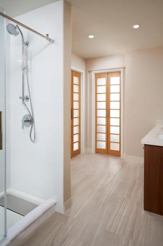 a bathroom with a shower and a sink at Delta Hotels by Marriott Toronto Mississauga in Mississauga