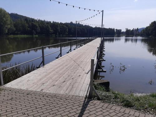 a wooden bridge over a body of water at Apartament Laurka in Kamienna Góra