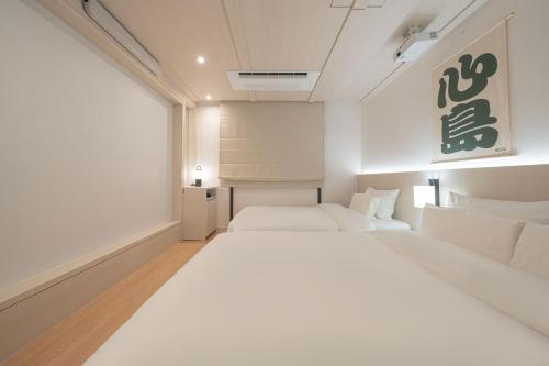 Postel nebo postele na pokoji v ubytování Simdo Hotel&Spa Sillim by Aank