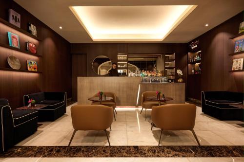 a lobby of a hotel with chairs and a bar at The First Arte - Preferred Hotels & Resorts in Rome