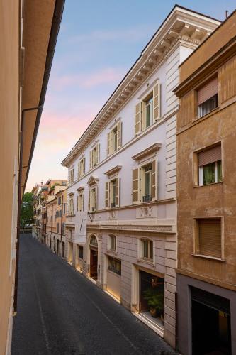 an empty city street with a white building at The First Arte - Preferred Hotels & Resorts in Rome