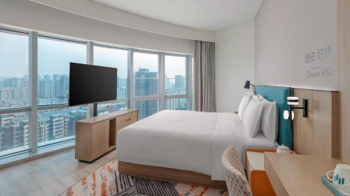 a hotel room with a bed and a flat screen tv at EVEN Hotel Yinchuan Yuehai by IHG in Yinchuan