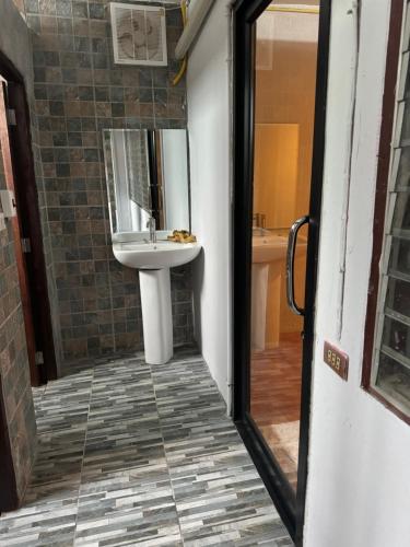 a bathroom with a sink and a mirror at Dikachaya Hostel in Chaweng