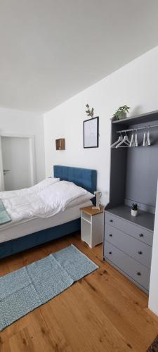 a bedroom with a bed and a dresser at Apartments in Graz in Graz