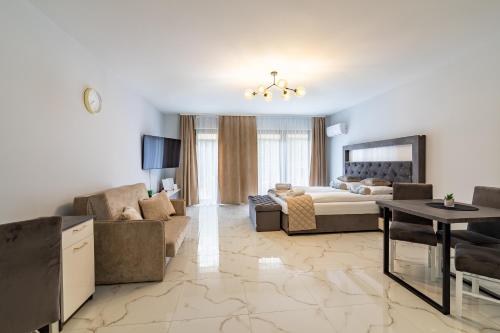 a large living room with a bed and a couch at Katowice Apartamenty Hetmańska 4 in Katowice