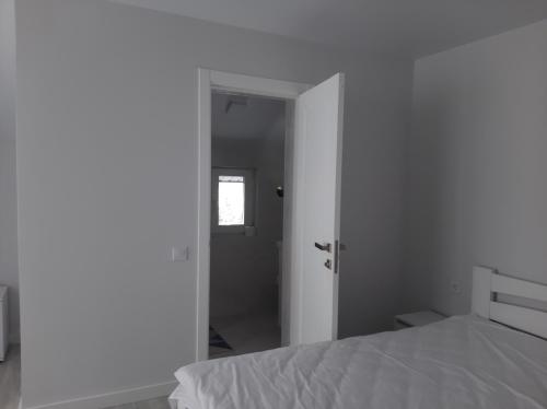 a bedroom with a white bed and a mirror at Софія in Yablunytsya