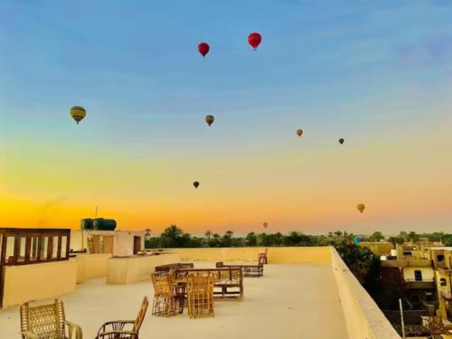 a group of kites flying in the sky on a roof at Rose Guest House in Luxor