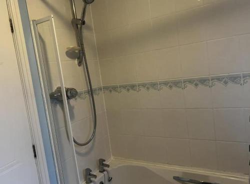 a bathroom with a shower and a sink at Brades Rise Retreat - Cozy 3 Bedroom House in Oldbury