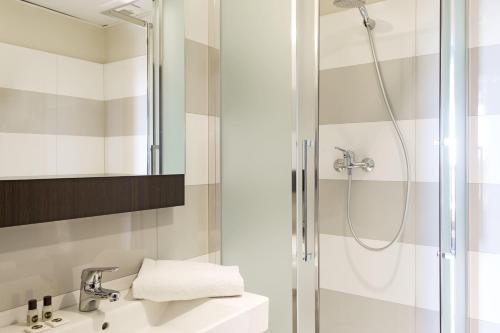 a bathroom with a shower and a sink at B&B Hotel Napoli in Naples