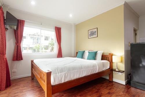 a bedroom with a large bed and a window at Kamala Beach Residence in Kamala Beach