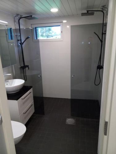 a bathroom with a shower and a toilet and a sink at New Heaven in Rovaniemi