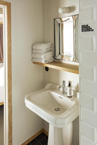 a bathroom with a sink and a mirror and towels at JAM Brussels in Brussels