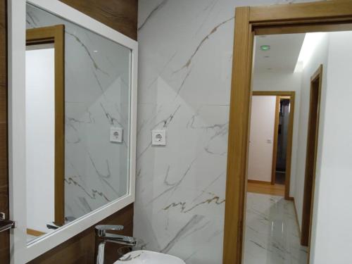 a bathroom with a mirror and a sink at La Juanita Bis in Praia
