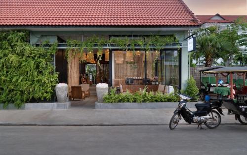 a motorcycle parked in front of a building at The Jungle in Siem Reap