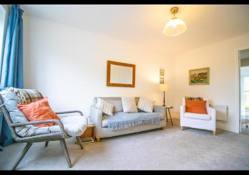 a living room with a couch and two chairs at Rosemary Cottage Camber Sands, East Sussex - 1 min to beach in Camber