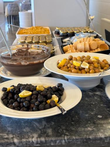 a buffet with plates of food on a counter at Dardanos Yerleşkesi in Hamidiye