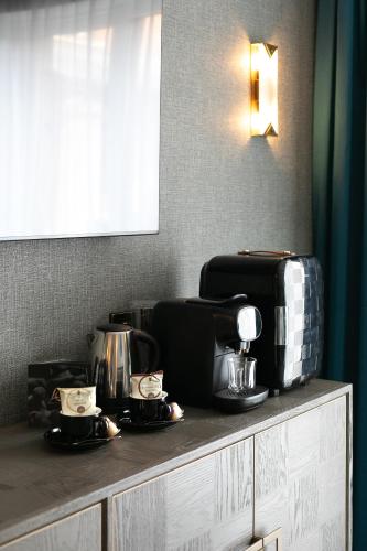 a counter with coffee makers and appliances on it at Cedar Court Bradford Hotel in Bradford