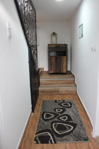 a hallway with a carpet on the floor and a stair case at Temački konaci in Pirot