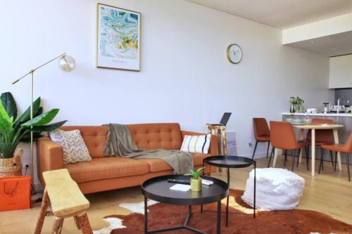 a living room with a couch and tables at Fantastic Waterview 1 bedroom apt for 4 sleeps in Sydney