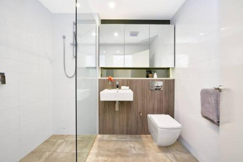 a bathroom with a toilet and a sink and a shower at Fantastic Waterview 1 bedroom apt for 4 sleeps in Sydney