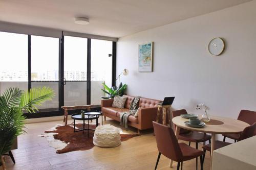 a living room with a couch and a table at Fantastic Waterview 1 bedroom apt for 4 sleeps in Sydney