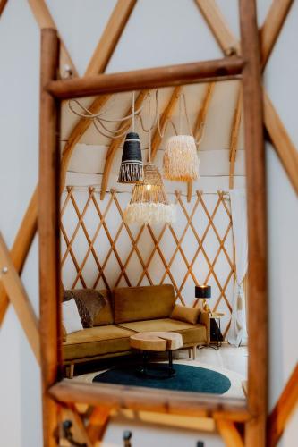 a living room with a couch and chandeliers at Osada JurtCamp w Witowie in Witówko