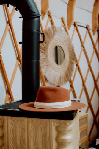 a hat sitting on a table next to a camera at Osada JurtCamp w Witowie in Witówko