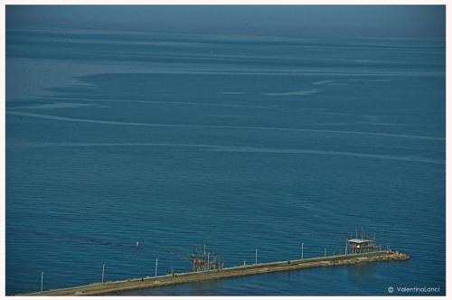 a dock in the middle of a body of water at B&B La Voce della Luna in San Vito Chietino