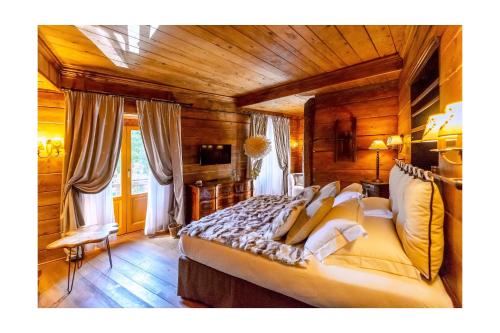 a bedroom with a large bed in a wooden room at Chalet BRAGARD in Limone Piemonte