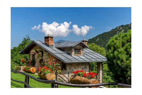 a house with flowers in front of it at Chalet BRAGARD in Limone Piemonte