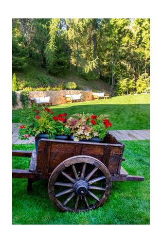 a wooden cart filled with flowers on the grass at Chalet BRAGARD in Limone Piemonte