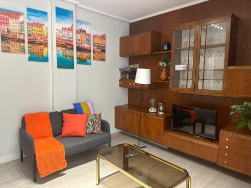a living room with a couch and a tv at Akelarre in Bilbao