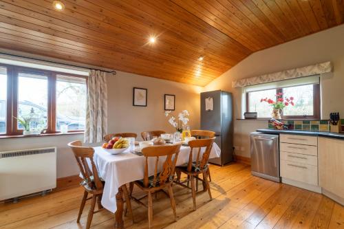 a kitchen and dining room with a table and chairs at The Lodge at Horton Hall Retreat in Skipton