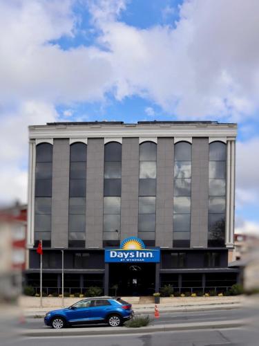 a blue car parked in front of a building at Days Inn by Wyndham Istanbul Arnavutkoy in Istanbul