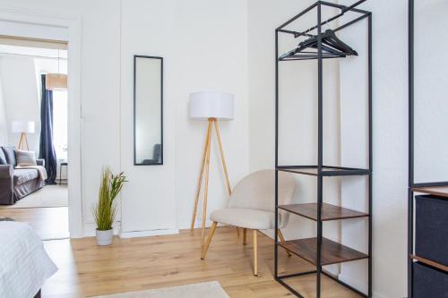 ein Wohnzimmer mit einem Stuhl und einem Regal in der Unterkunft stayVision FS43 Wohnung 7 - 1 Schlafzimmer - 4 Gäste - top WLAN in Wuppertal